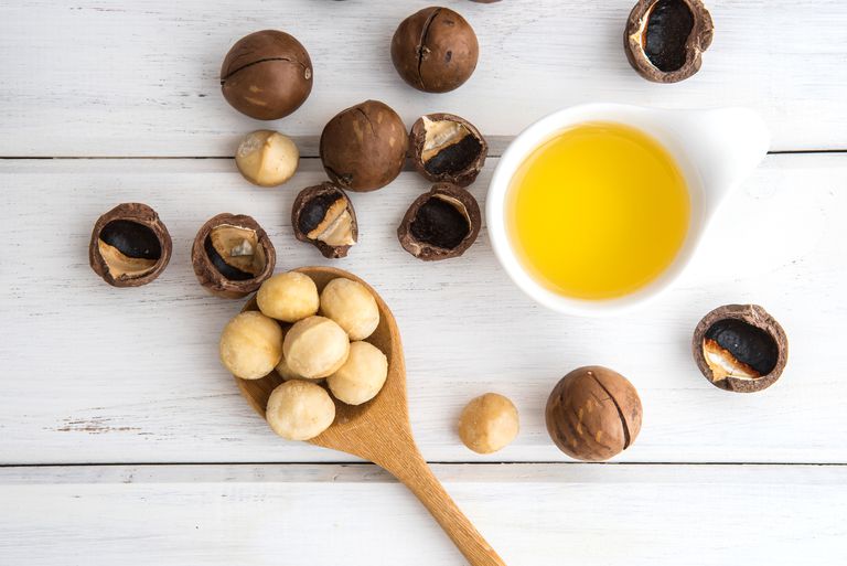 macadamia-nut-oil-and-peeled-macadamia-nut---on-white-table---use-for-healthy-skin-and-hair-and-natura